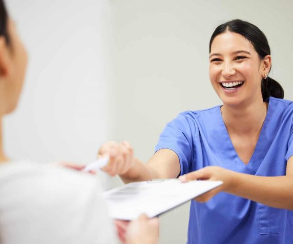 healthcare professional gives client form for Aetna insurance