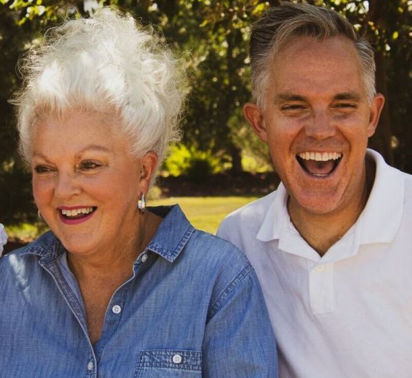 older couple stands together smiling as they heal from mental health issues