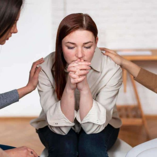 A group of close friends offering compassionate support to a friend facing mental health challenges, a powerful way of how to help someone struggling with mental health.