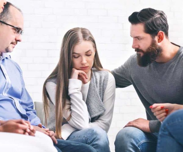 Supportive group therapy session in a specialized treatment center.
