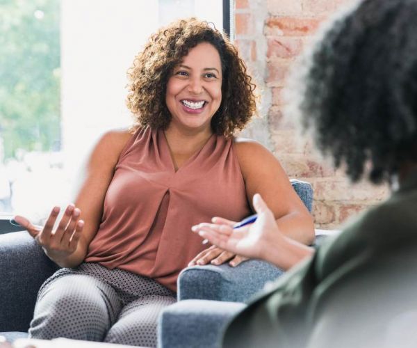 Two women having a conversation about how to find a PCP.