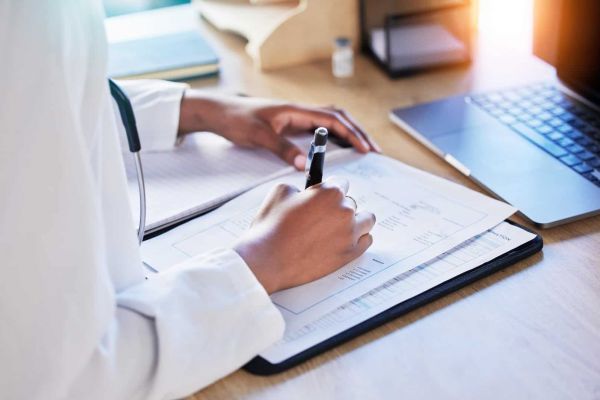 A medical professional assists a client with paperwork for Humana Healthcare in Nashville.