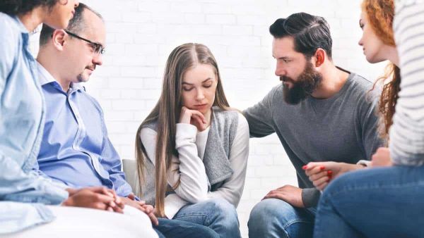 Supportive group therapy session in a specialized treatment center.