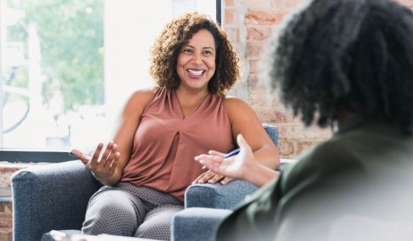 Two women having a conversation about how to find a PCP.
