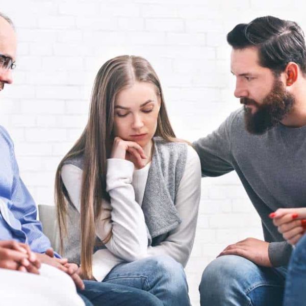 Supportive group therapy session in a specialized treatment center.