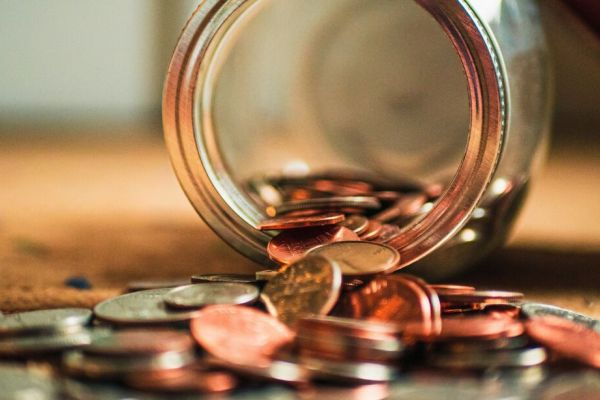 a jar lying on it's side with change coming out representing mental health treatment