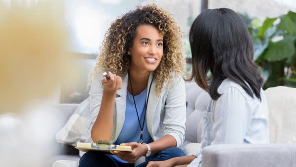 Two women having a conversation about how to find a PCP.