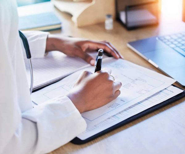 A medical professional assists a client with paperwork for Humana Healthcare in Nashville.