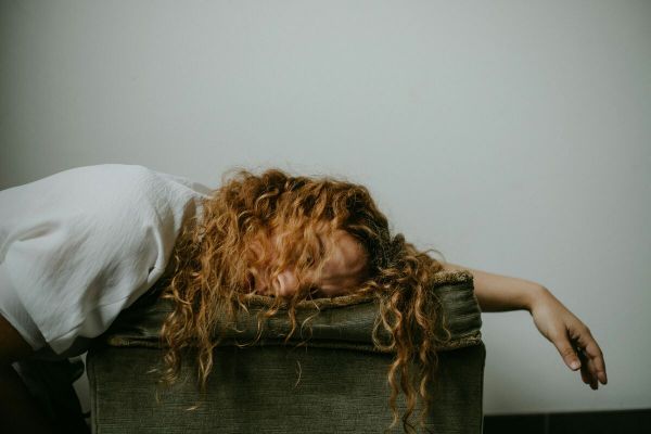 girl lays on the bed struggling with mental health issues