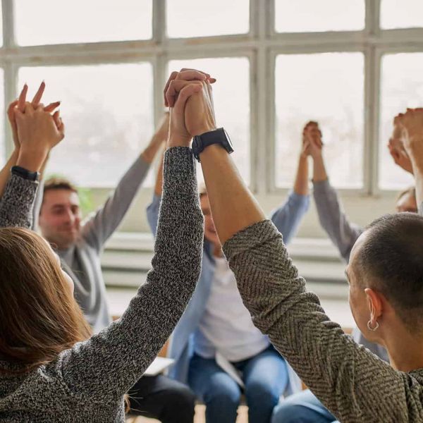 a group of people holding hands as they heal from mental health issues