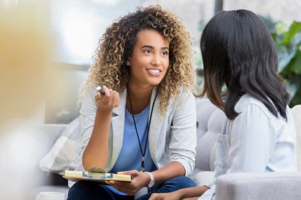 Two women having a conversation about how to find a PCP.