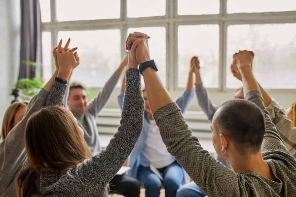 a group of people holding hands as they heal from mental health issues