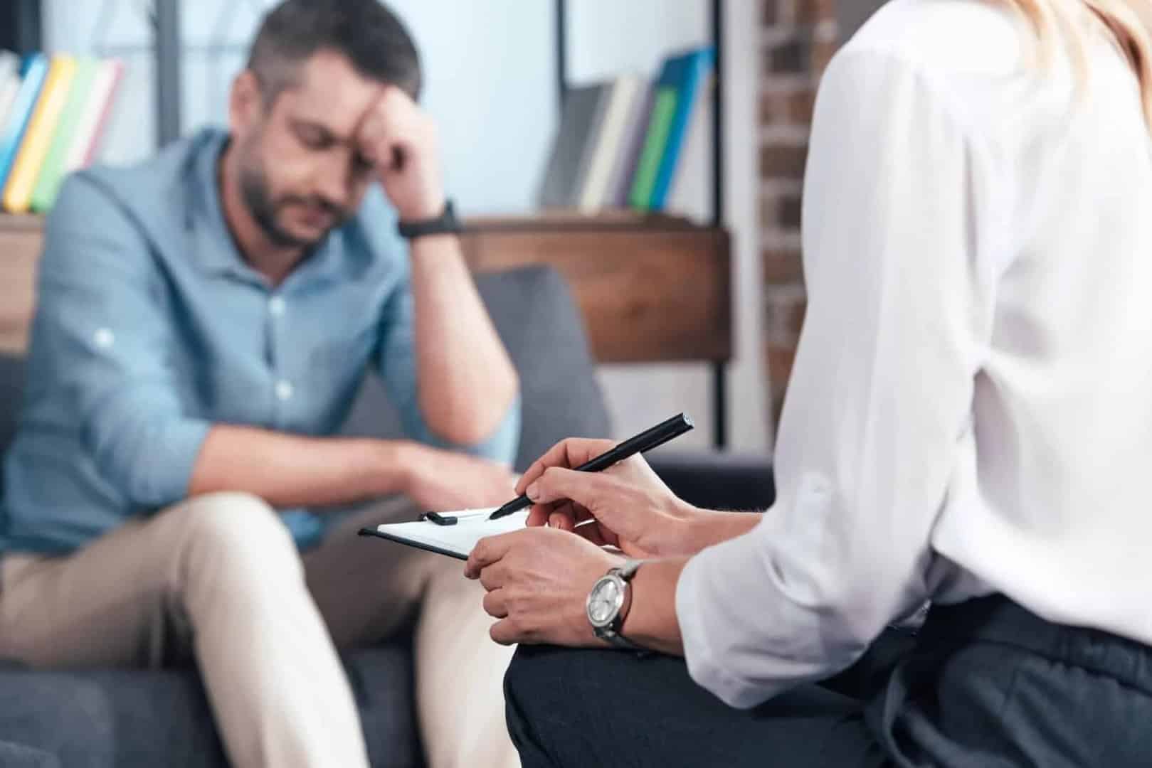 man sits with a doctor as he does a mental health assessment