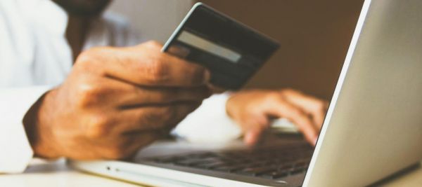 A person holding a credit card to pay for mental health treatment therapy