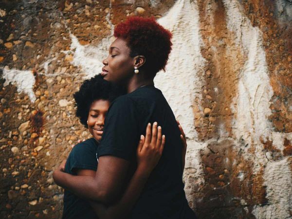 A mother hugs her son as she recovers from mental health issues