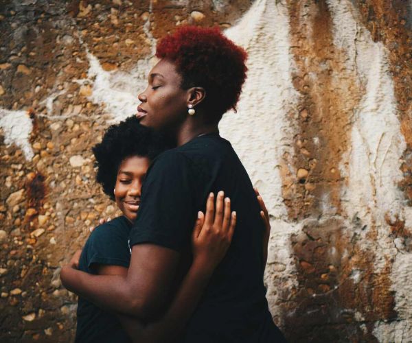 A mother hugs her son as she recovers from mental health issues