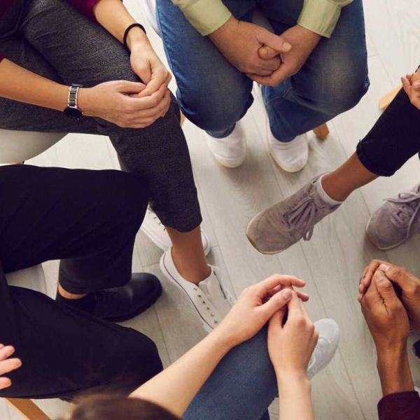 A group of people sit in a circle to recover from mental health struggles