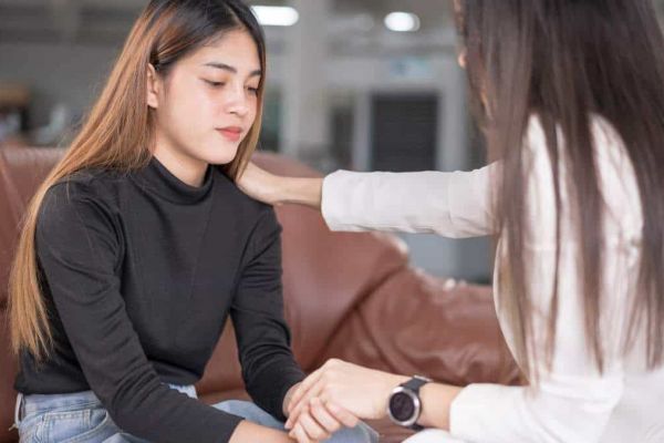 Female patient getting support from therapist during depression treatment in Nashville