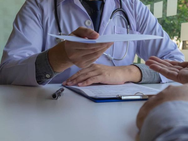 A person holding a credit card to pay for mental health treatment therapy