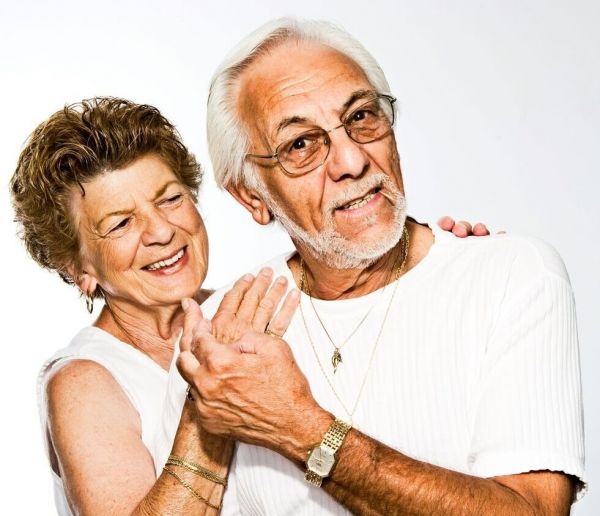 older couple stands together smiling as they heal from mental health issues