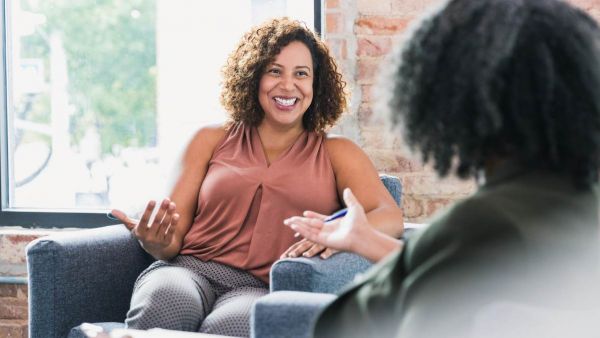 Two women having a conversation about how to find a PCP.