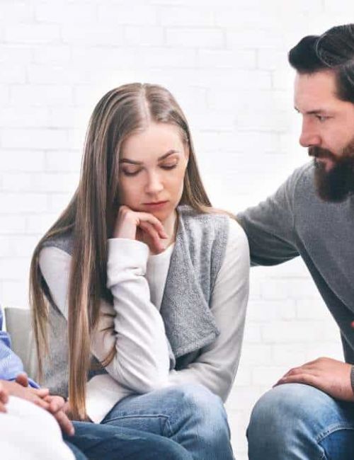 Supportive group therapy session in a specialized treatment center.