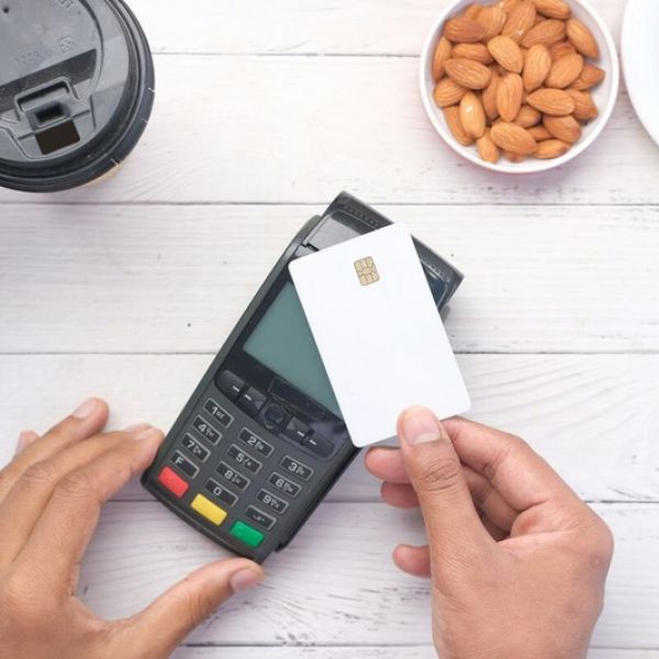 A person holding a credit card to pay for mental health treatment therapy