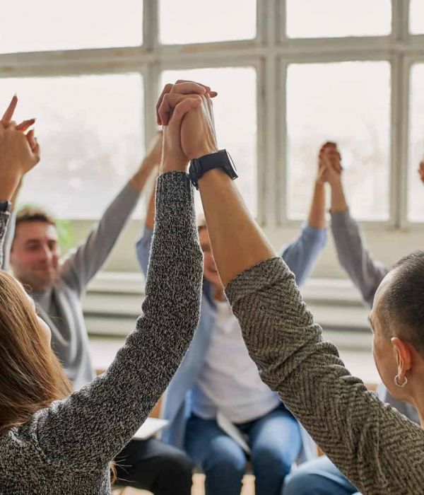 a group of people holding hands as they heal from mental health issues