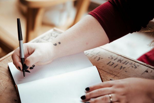 girl writing down her feelings as she recovers from mental health issues