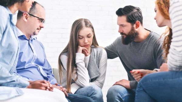 Supportive group therapy session in a specialized treatment center.