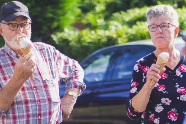 older couple stands together eating ice cream as they heal from mental health issues