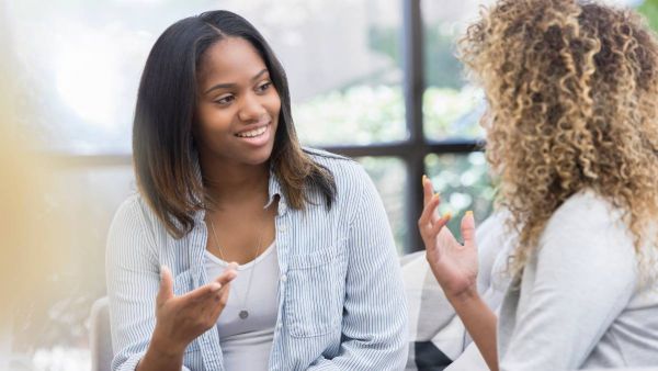 A woman during a meet-and-greet appointment discussing with an expert how to find a PCP that best meets her needs.