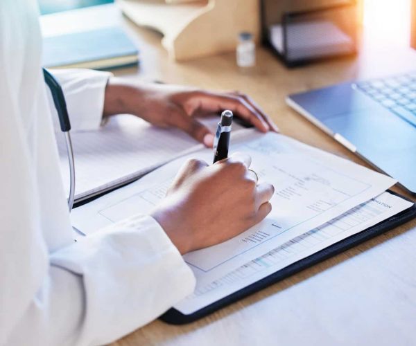 A medical professional assists a client with paperwork for Humana Healthcare in Nashville.