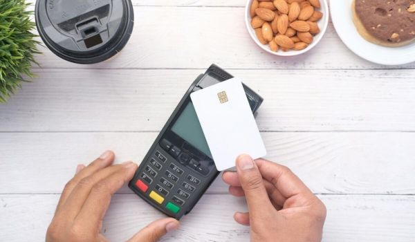 A person holding a credit card to pay for mental health treatment therapy