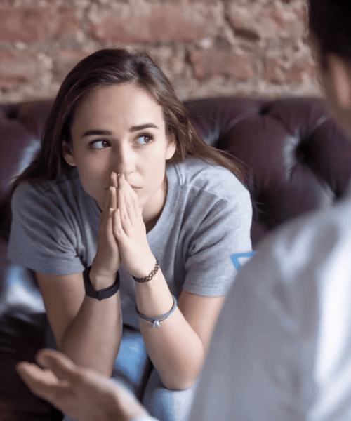 girl sitting in therapist office discussing mental health treatment options