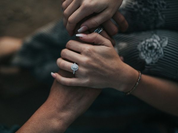 Two people holding hands as they support each other with mental health struggles