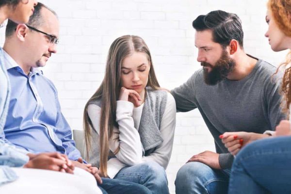 Supportive group therapy session in a specialized treatment center.