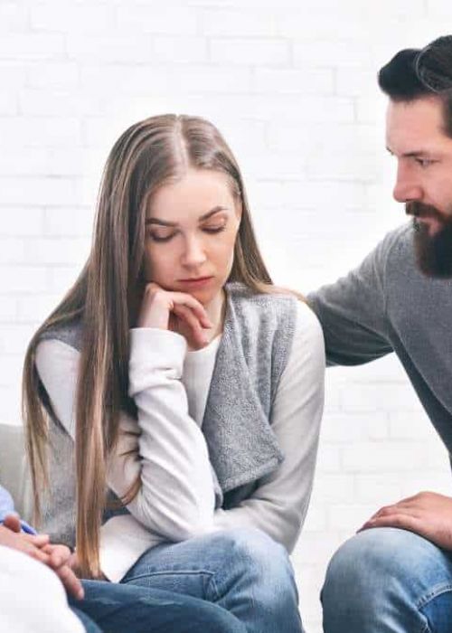 Supportive group therapy session in a specialized treatment center.