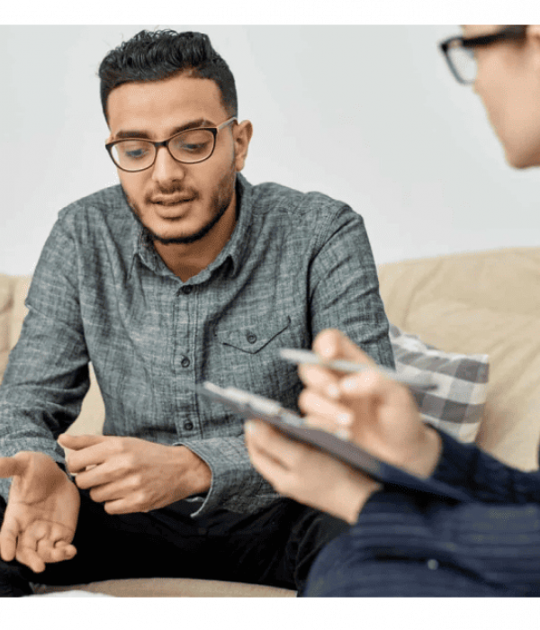 man sitting in therapist office discussing mental health treatment options