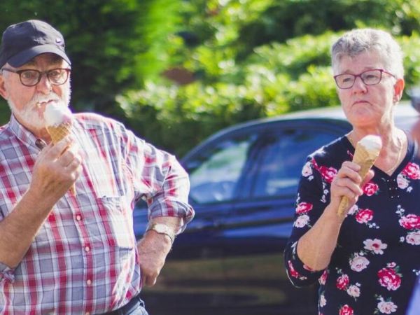 older couple stands together eating ice cream as they heal from mental health issues