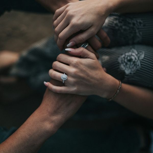 Two people holding hands as they support each other with mental health struggles