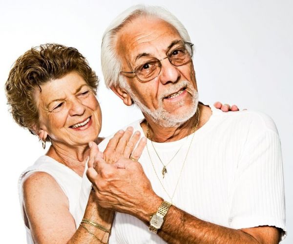 older couple stands together smiling as they heal from mental health issues